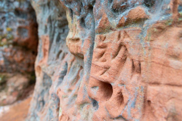 istock A beautiful sandstone cliff wall with engraved markings. 2101128982