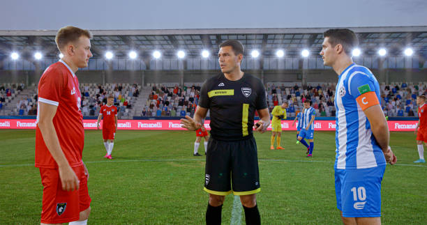istock Referee with team captions on football pitch 2101133149