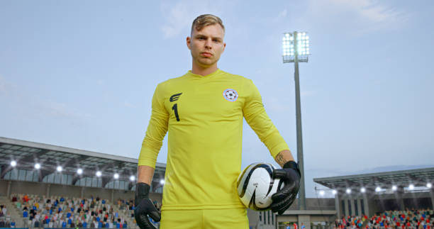 istock Goalkeeper standing on football pitch 2101134228
