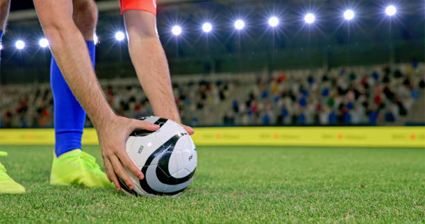 istock Football player adjusting ball 2101134757
