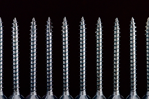 Close up of a large group of countersunk lag bolts for joining wood parts