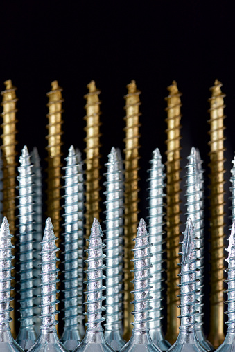 Close up of a large group of countersunk lag bolts for joining wood parts