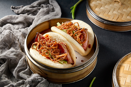 Gourmet Bao buns with roast beef and crispy fried onions; a modern twist on a classic Asian dish.