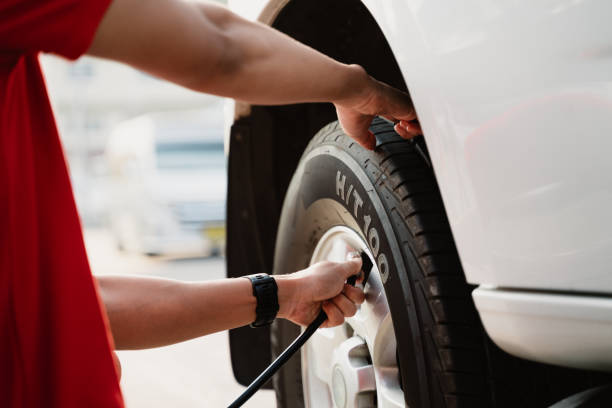 istock A man is inflating a tire with a tire inflator 2101223488