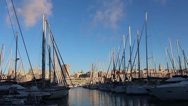 Panoramic view of old port of Marseille with yachts reflected in water, Marseille, France. Taken from hand.