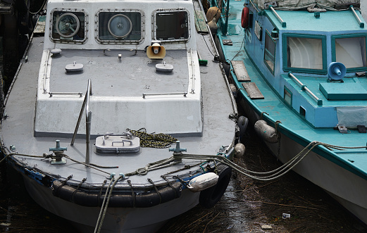A workboat moored with a rope in the port of Yokohama Port City, Japan
