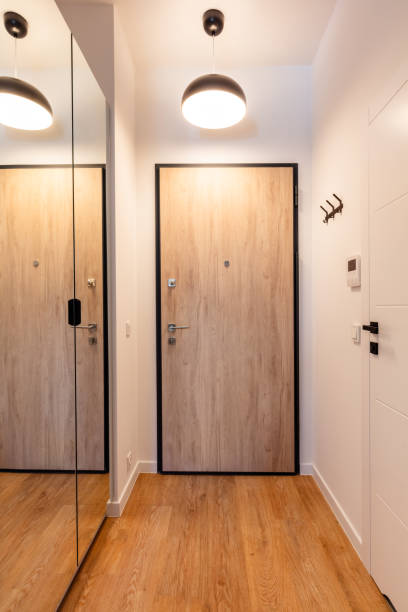 istock Contemporary hall with wooden doors and pendant lights 2101248799