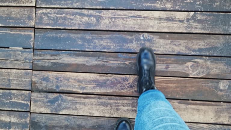 Close-up of human feet, wooden flooring