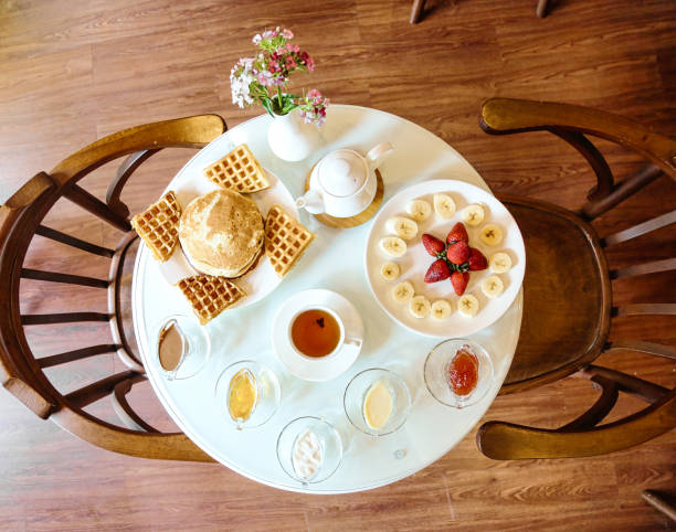 A white table is topped with a plate of delicious food, featuring an assortment of flavors and ingredients.