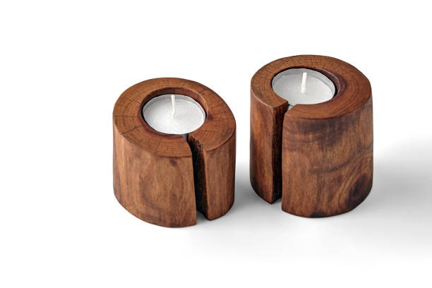 istock Two sawn wood candlesticks with crackle and pillar candles isolated on a white background 2101257793