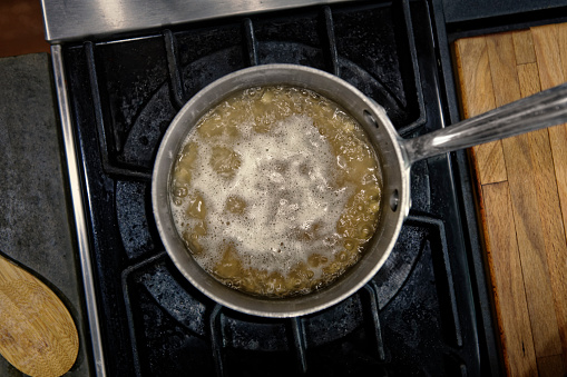 An overhead view of a pot of steaming soup