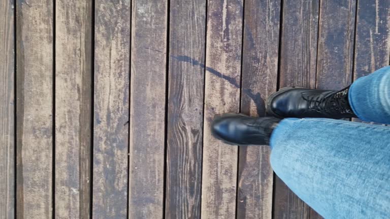 Close-up of human feet, wooden flooring