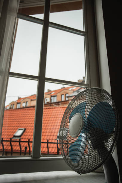 istock Electric fan on the windowsill for cooling 2101273957