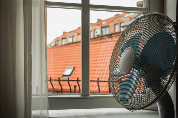 istock Electric fan on the windowsill for cooling 2101274209