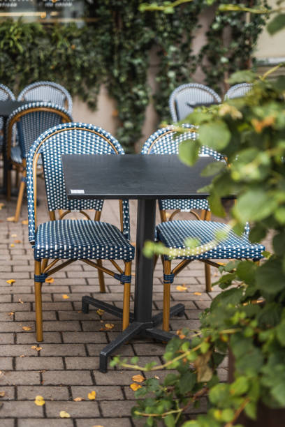 istock Wicker chairs at a table in a street cafe 2101274228