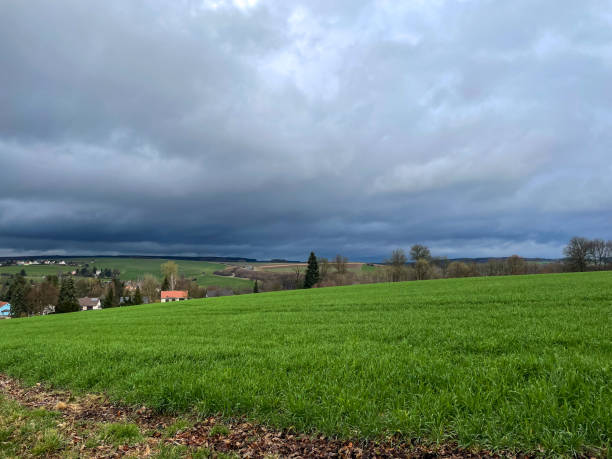 istock Dark storm clouds gather over a village 2101274744