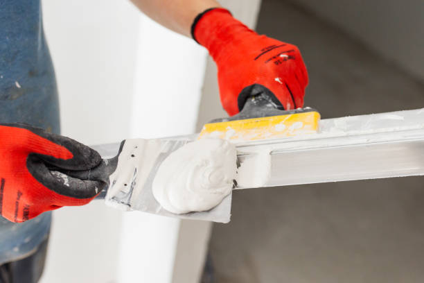 istock A professional builder levels the walls with putty 2101275843