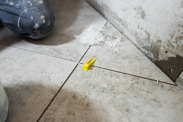 istock Professional qualified tiler work - installation of tiles 2101276375