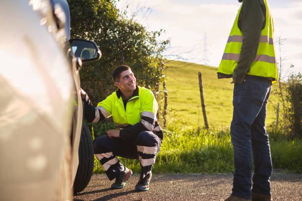 Man receiving roadside assistance from a mechanic