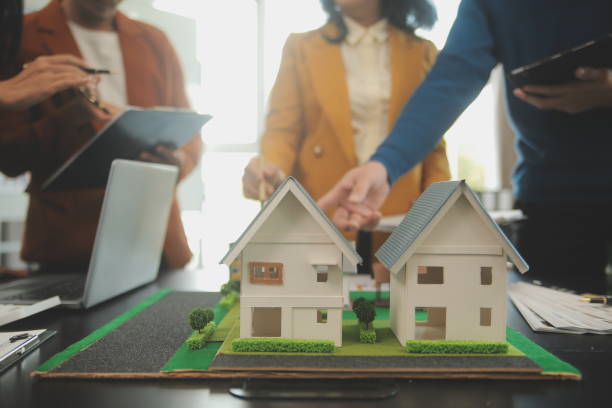 istock Team of architectures and businessmen discussing and brainstorming on floor plan modification for real estate investment and housing development project 2101300194