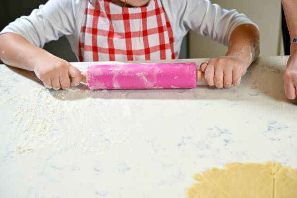 istock Little cool girl rolling dough 2101304525