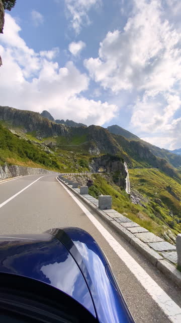Car driving on a mountain road surrounded by incredible scenery