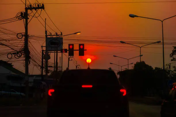 Sunset in the evening, with a mess of electrical wires on the road.traffic light on dark light.