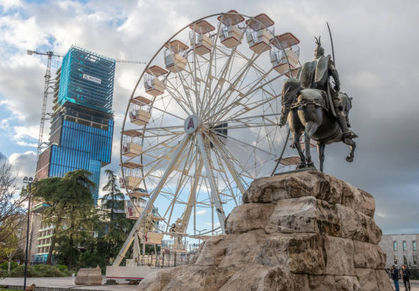 Tirana, Albania. 13 March 2024. Ferris Wheel ride in Skanderbeg Square with new skyscrapers being built.