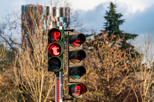 traffic control semaphore with stop light on a defocused city background