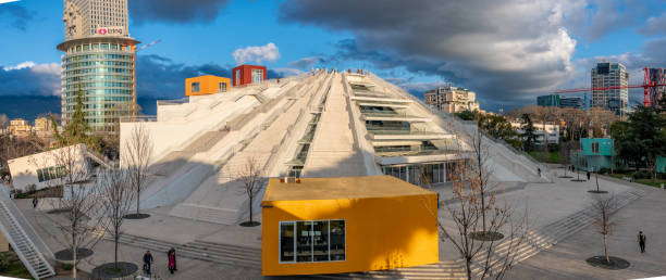 Tirana, Albania. 13 March 2024. Overcast at the Pyramid of Tirana with people on the steps.