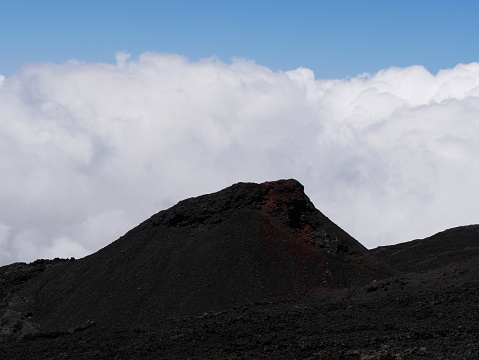 Eruptive cone of Fournaise volcano on top of the clouds, Reunion, France, small crater