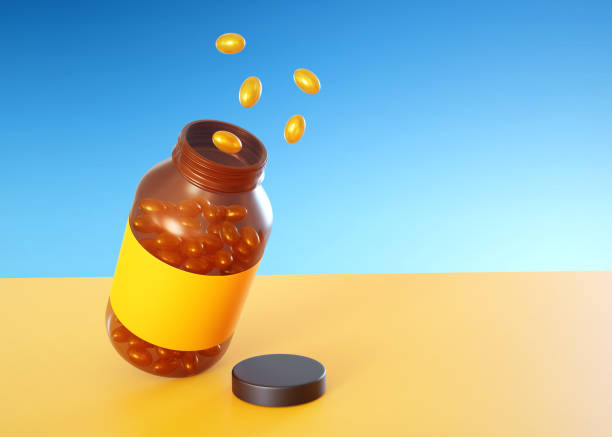 желтые таблетки с пластиковым медицинским флаконом - vitamin a vitamin b complex pill bottle medicine стоковые фото и изображения