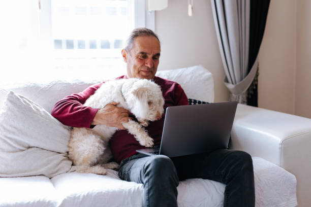 istock The old man who works at home with his puppy 2101403245