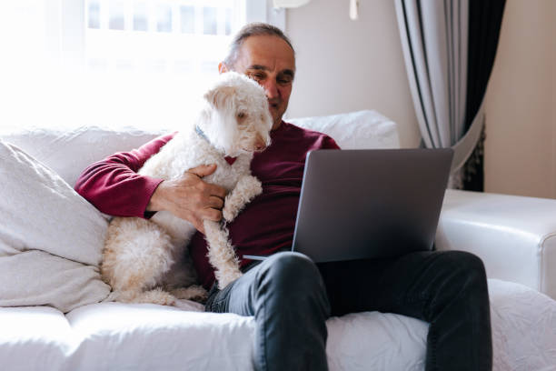 istock The old man who works at home with his puppy 2101404292