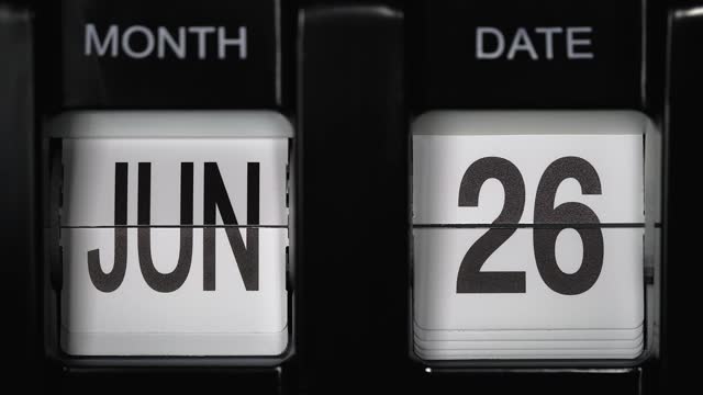 retro flip calendar with date change from twenty-fifth of June to twenty-sixth of June. close up.