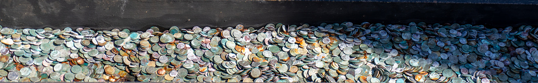 Coins gathered in the slots around Liberty Ferry Terminal in Battery Park