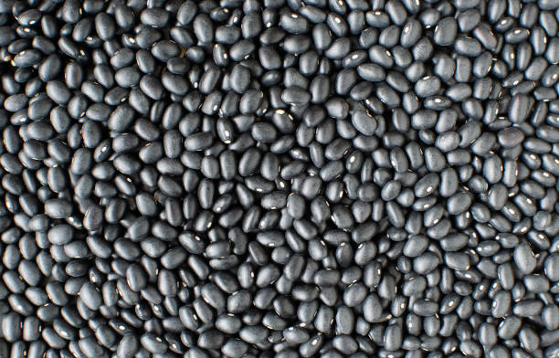 Raw black bens background. Concept of healthy eating. Vegetarian and vegan food. Vertical orientation. Top view. Selective focus. stock photo