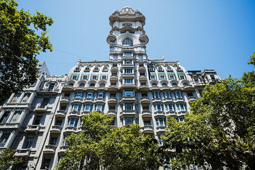 Ornate building facade under blue skies in Buenos Aires, showcasing architectural beauty.