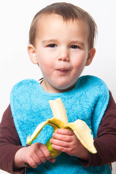 istock Toddler savouring a tasty banana. 2101464570