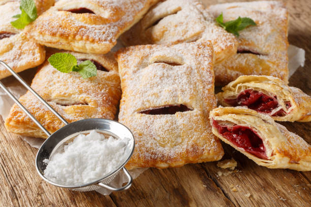 istock Sweet berry puff pastry with powdered sugar and mint close-up. Horizontal 2101466885