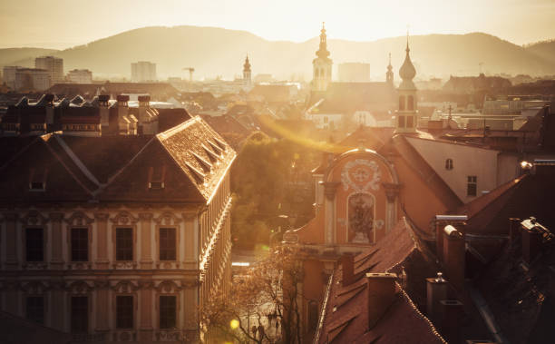 Graz, Austria - November 01, 2013: City overview from Kriegssteig with buildings near Schloßbergplatz in the middle and tiled roofs of buildings around.