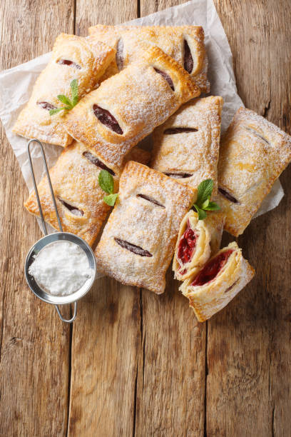 istock Puff pastry filled with cherry jam close-up. Vertical top view 2101467972