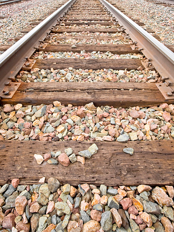 American railway with oak cross beams against a stone gravel (USA)