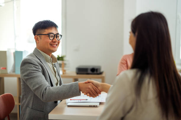 istock Colleagues shaking hands at the office 2101477261