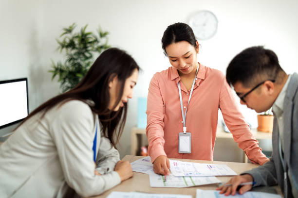 istock Group of young colleagues working together at small office, discussing work and ideas 2101477680