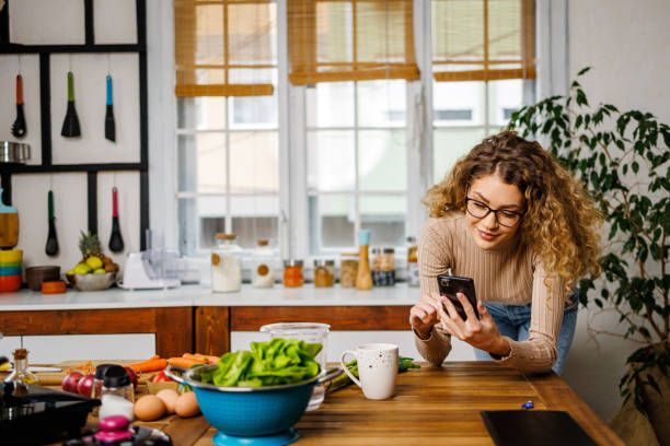 istock Smiling woman typing message on smartphone 2101482342