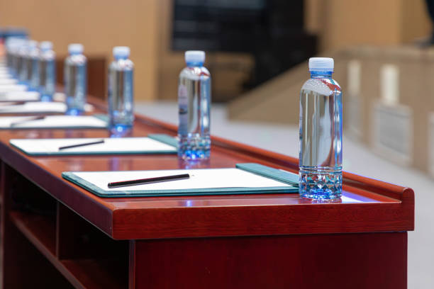 istock On the conference table, there are neatly arranged white papers and pencils 2101482650
