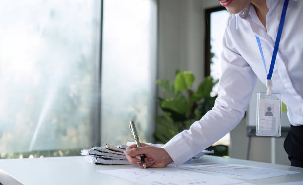 istock A businesswoman with determination takes note, write work plan and graphs the company's financial schedule in her office. 2101484882
