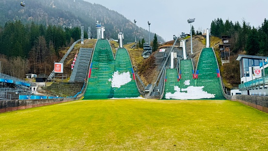 The Muehlenkopf ski jump in Willingen, Germany. The stands are deserted, it's snowing and it's optimal conditions for ski jumping.