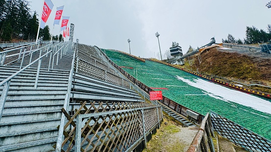 Oberstdorf, Germany - March, 16th - 2024: Schattenberg ski jump hillside with standing room for spectators directly at the jump hill.